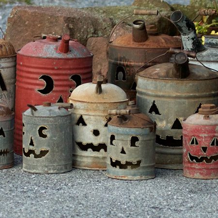 Vintage antique gas cans with jack-o-lantern faces cut into each by Tish, Mike and Ian Bachleda. Selection varies.